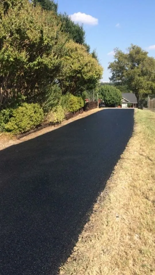 Newly paved asphalt driveway in El Reno, OK, showcasing Arrow Asphalt LLC's residential paving services.
