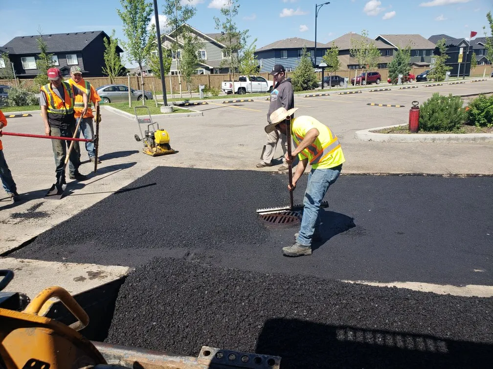 Arrow Asphalt LLC crew paving asphalt driveway in Norman, OK.