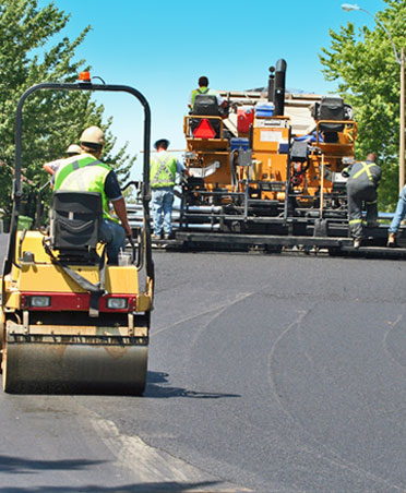 Arrow Asphalt LLC: Asphalt paving crew working on new road construction in Oklahoma City.