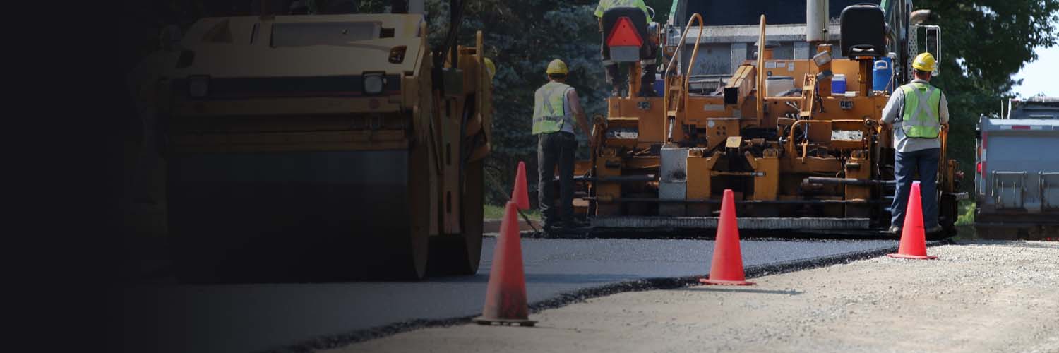 Arrow Asphalt LLC crew paving asphalt driveway and parking lot with heavy equipment.