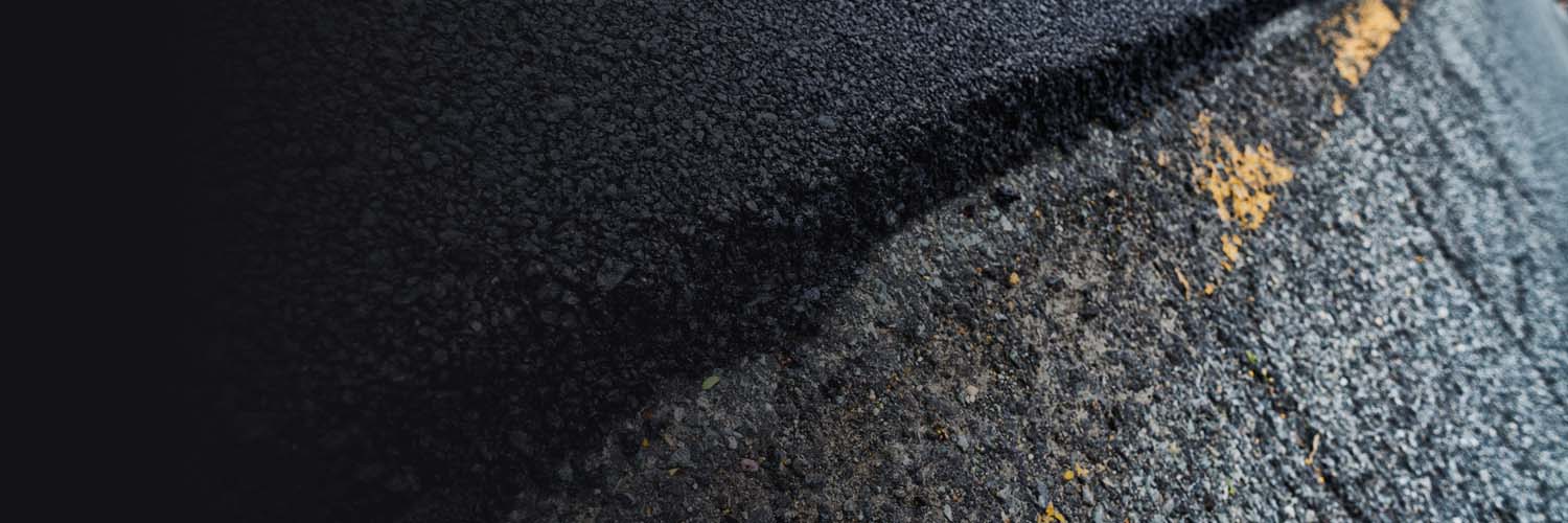 Asphalt resurfacing process with milling and overlay for Oklahoma driveways and parking lots.