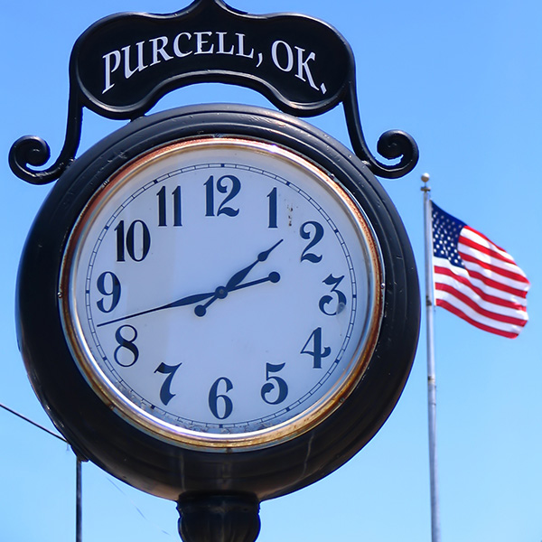 Purcell, OK town clock and American flag representing the "Heart of Oklahoma."